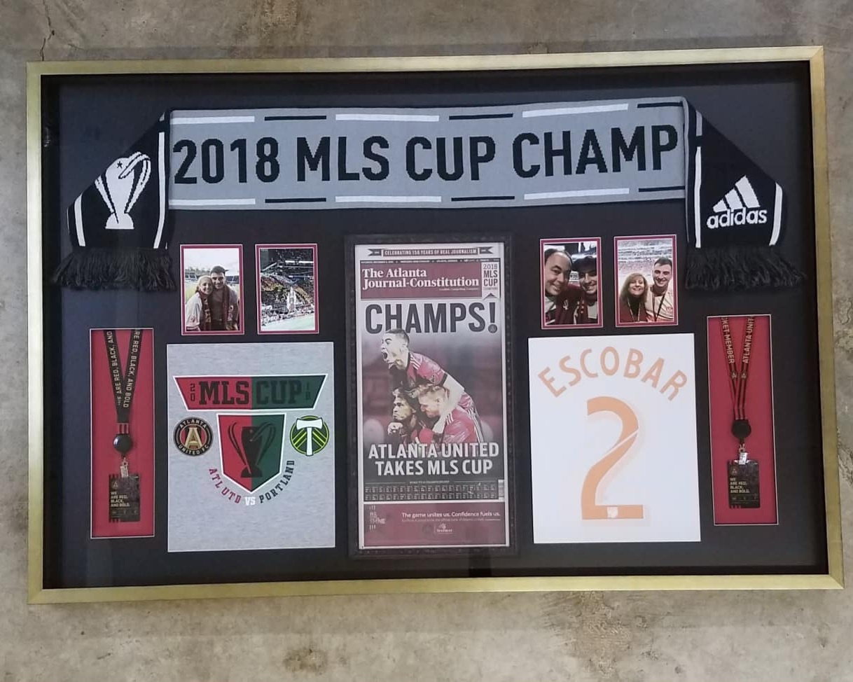 Framed sports memorabilia and jersey shadow box